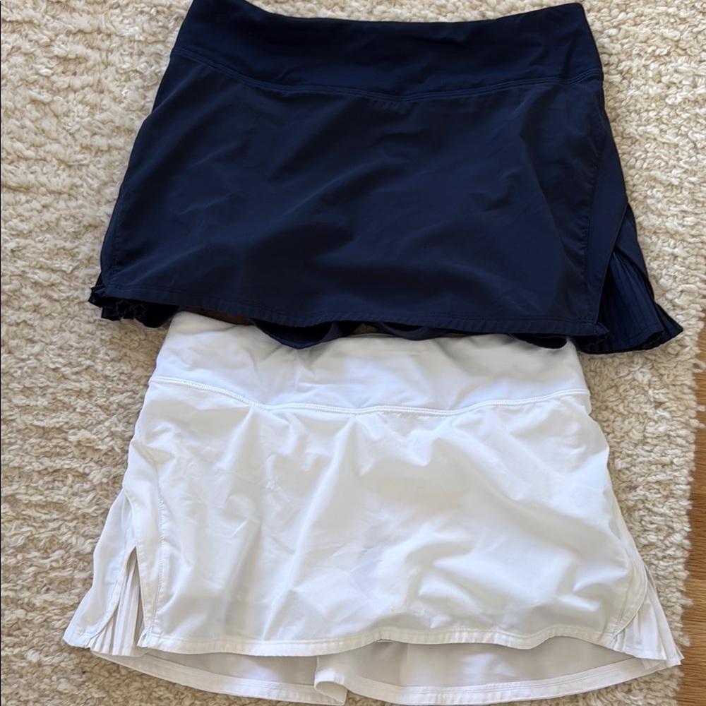 Two lululemon tennis skirts, navy and white